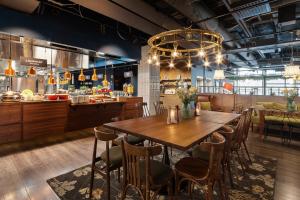 a dining room with a large wooden table and chairs at Original Sokos Hotel Wiklund in Turku