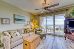 a living room with a couch and a tv at The Dunes #707 in Gulf Shores