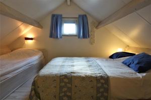 Ένα ή περισσότερα κρεβάτια σε δωμάτιο στο Vakantiehuis Merel