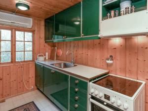 a kitchen with green cabinets and a sink at 4 person holiday home in Bog By in Bogø By