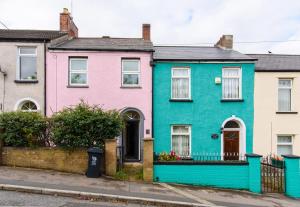 a row of colourful houses on a street at Railway Cottage in Newport