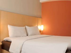 Letto o letti in una camera di Ibis Padang