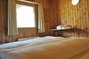 a bedroom with a bed and a window at Hotel Bergalga in Am Bach