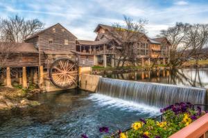 a home with a mill and a waterwheel at Wildwood in Pigeon Forge