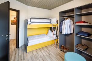 a room with two bunk beds and a closet at Basekamp Mountain Budget Hotel in Katschberghöhe +31 photos