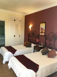 a hotel room with three beds in a room at Hotel La Peña in Tarifa