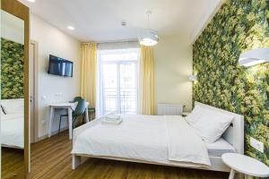 a hotel room with a bed and a window at BonApart Delux in Lviv