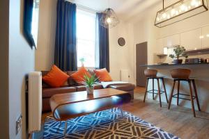 a living room with a couch and a table at The Matcham at Claremont Apartments in Leeds