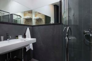 a bathroom with a shower and a sink and mirror at Familia in Vathi