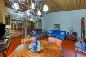 a living room with a table and a blue couch at Huntington Lair Condominium in Lakeshore