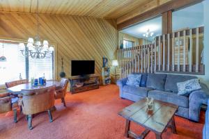 a living room with a blue couch and a table at Huntington Lair Condominium in Lakeshore