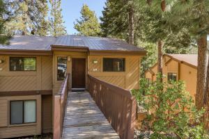 a house with a wooden walkway leading to the front door at Huntington Lair Condominium in Lakeshore