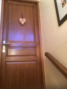 a wooden door with a heart sign on it at Clos des Cailloux in Prades-le-Lez
