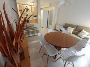 a living room with a table and chairs and a couch at Lo Peressall Blanc in Tremp