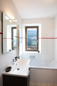 Baño blanco con lavabo y espejo en ETOILE LODGE en Hauteluce