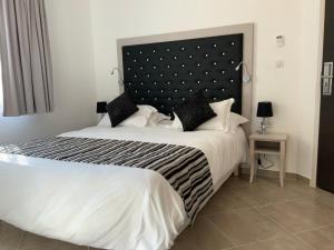 a bedroom with a large bed with a large headboard at A STORIA in Bastia