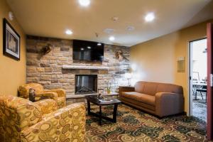 a living room with a couch and a fireplace at Cobblestone Inn & Suites - Eads in Eads