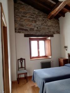 A bed or beds in a room at La Corte del Rondiellu 1