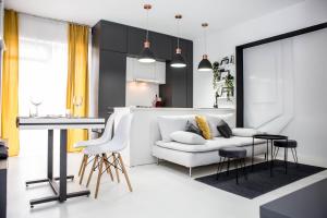 a living room with a white couch and a table at cosy ELFs crib 1, Voluntari ,free parking, self check in and check out, by ELF properties in Voluntari