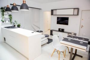 a kitchen and dining room with a table and chairs at Cazare Voluntari in Voluntari
