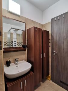 uma casa de banho com um lavatório e um espelho em Luna apartment em Budapeste
