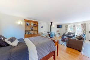 a bedroom with a bed and a living room at Seasons in Seal Cove in Seal Cove