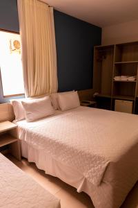 Кровать или кровати в номере Pousada Mariluz