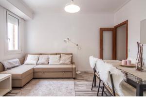 a living room with a couch and a table at Nordic Apartment II Sagrada Familia in Barcelona