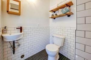 a bathroom with a toilet and a sink at Pueblo Street Tiny Home in Boise