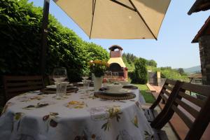 グレーヴェ・イン・キアンティにあるVilla Dei Sogniの白いテーブルクロスと傘付きテーブル