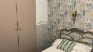 バルバストロにあるHostal Pirineosのベッドルーム1室(木製ヘッドボード付きのベッド1台付)