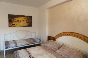 a bedroom with two beds and a painting on the wall at B&B IL CAVALIERE in Baronissi