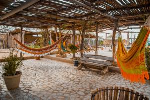 a patio with hammocks and a bench in a building at Del Mar Vendra in Manaure Viejo