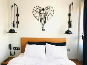 a bedroom with a bed with two lights above it at Barkod Otel in Istanbul