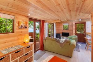 a living room in a tiny house at Porthole Log Cabin in Minehead