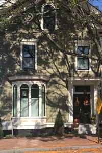 a white house with a tree in front of it at A Foodies Delight and Cumberland Charm in Portland
