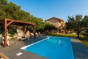 a swimming pool in a yard with a house at Penelope Dream Pool Villa in Minia