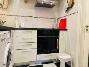 a small kitchen with a stove and a dishwasher at Excellent 2 bedroom apartment in Lisbon in Lisbon