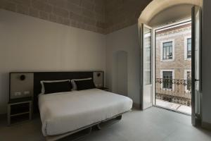 Ένα ή περισσότερα κρεβάτια σε δωμάτιο στο Le Dimore dell'Acqua
