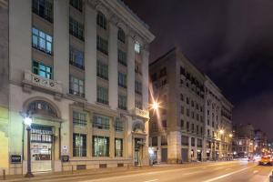 una strada cittadina con due edifici alti di notte di Exe Laietana Palace a Barcellona