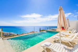 a swimming pool with a view of the ocean at Villa Tierra in Nerja