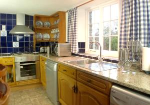 a kitchen with a sink and a counter top at Old Newham Farm in Camelford