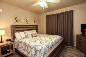 a bedroom with a bed and a dresser and a television at Riverside Retreat in New Braunfels +16 photos