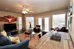 a living room with a large wooden table and chairs at Riverside Retreat in New Braunfels