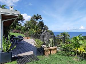 una terraza de madera con vistas al océano en Domaine Choco Vanille, en Deshaies