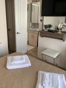 a bathroom with two towels sitting on a bed at Logi - Bear in Felton
