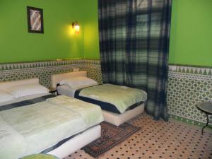 Postel nebo postele na pokoji v ubytování Riad Passiflora