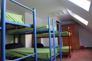 a bunk bed room with two bunk beds and a staircase at Albergue de Canfranc Estación in Canfranc-Estación