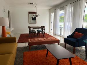 a living room with a couch and a table at Cheston House - Clothing Optional All Male Guesthouse in Fort Lauderdale
