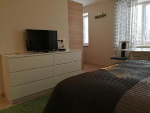 a bedroom with a dresser with a television on it at VIN service Atbrivosanas alley 101 in Rēzekne